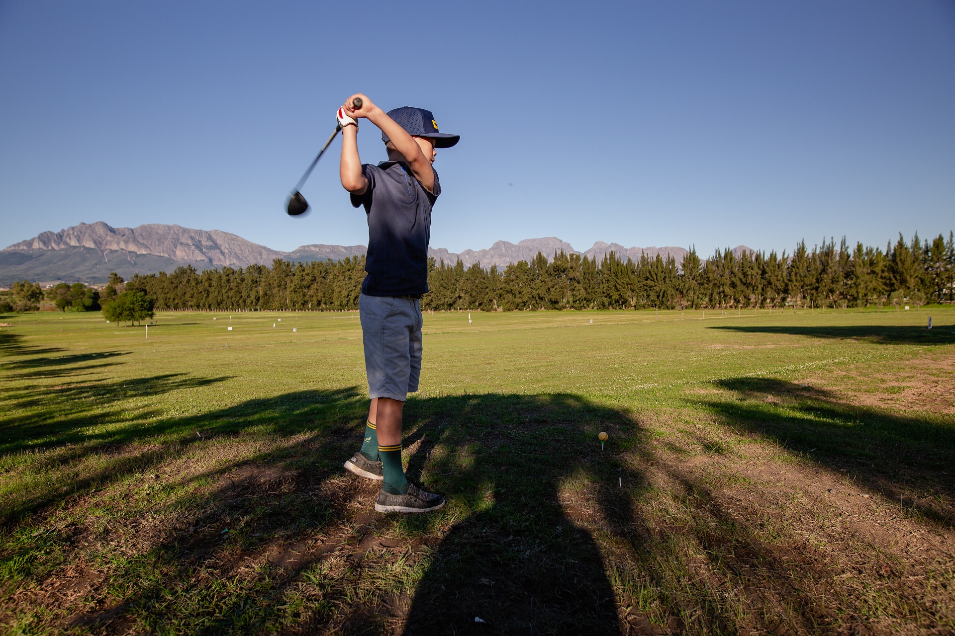 Golfer practicing at the Mayerskraal golf driving range with mountain views in the Cape Winelands