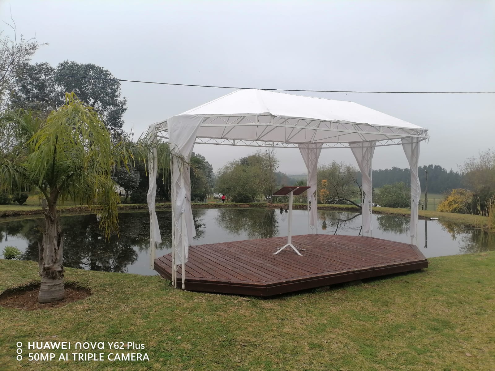 White outdoor wedding ceremony pavilion overlooking the pond at Mayerskraal Wedding Venue.