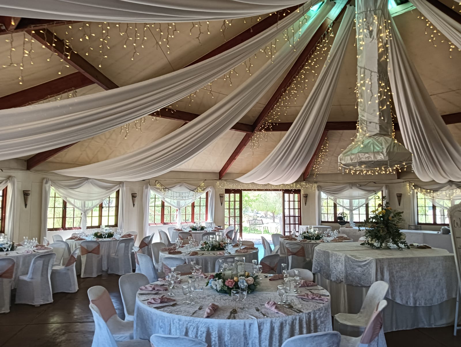 Elegant wedding reception setup with draped ceiling and fairy lights at Mayerskraal Wedding Venue