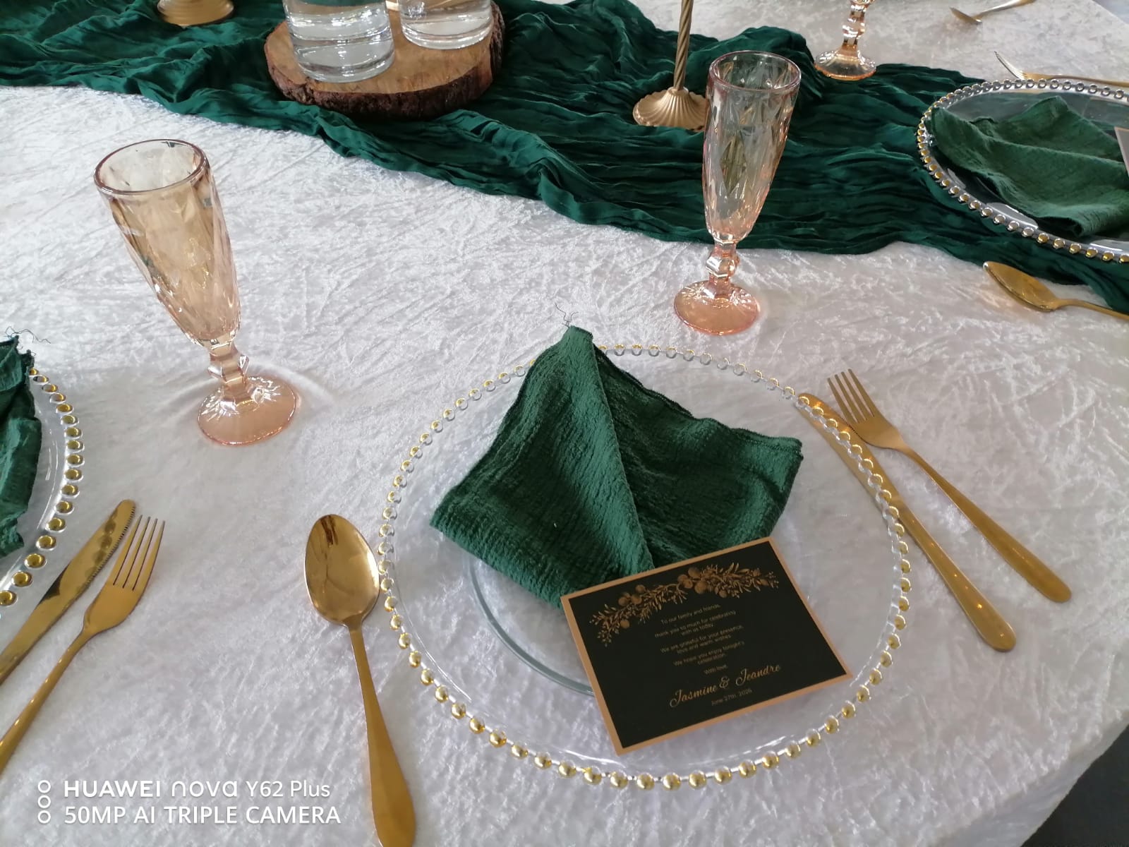 Elegant wedding table setting with green napkins, gold cutlery and candle centerpieces at Mayerskraal Wedding Venue